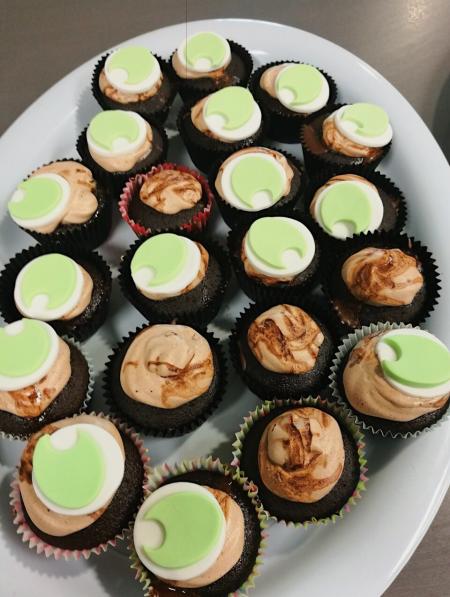 Photo of mini chocolate cupcakes with green koha logo shaped icing