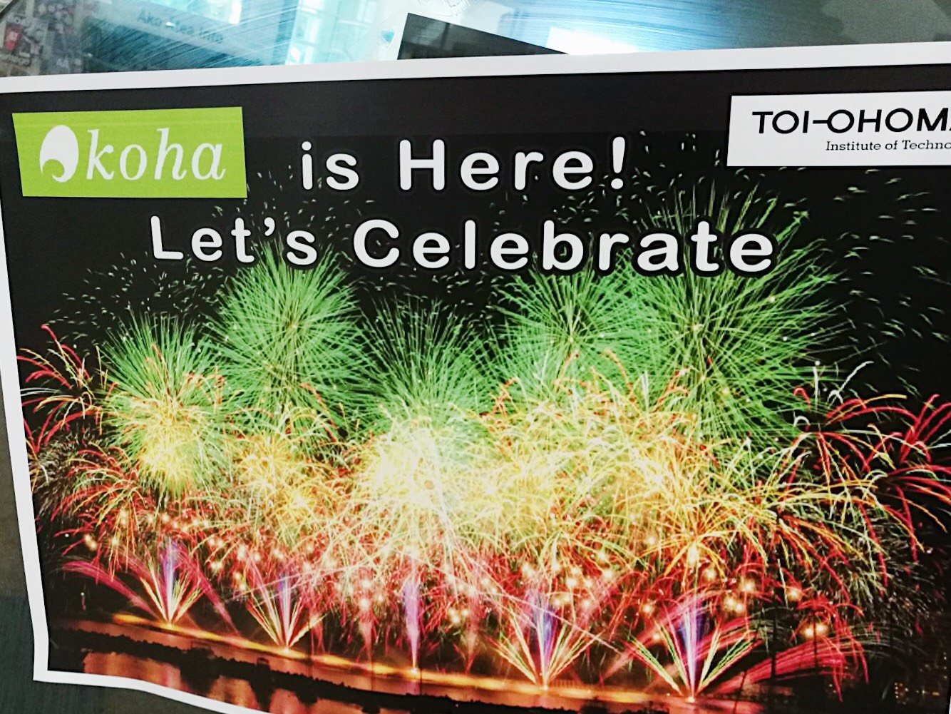 Let's celebrate, Koha is live! photo of a poster with fireworks in red, green and blue, with 'Koha is here! let's celebrate' text
