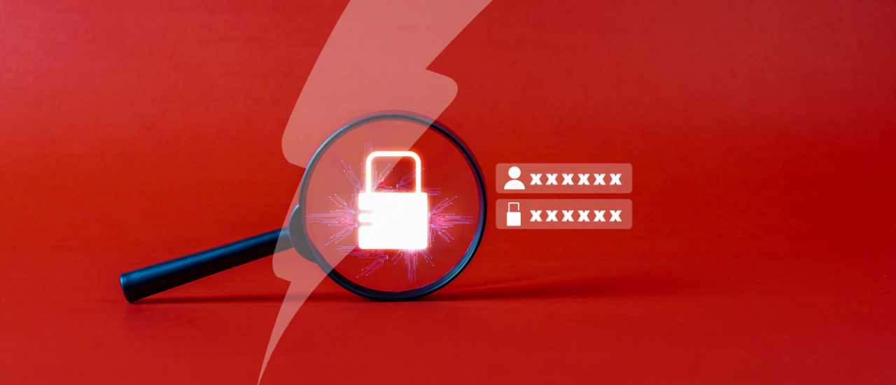 A magnifying glass rests on a red background, focusing on a glowing digital padlock symbol, representing cybersecurity. To the right, stylised login fields with obscured usernames and passwords are displayed, suggesting themes of data protection and secure access. A semi-transparent lightning bolt graphic overlays the image, adding visual emphasis.